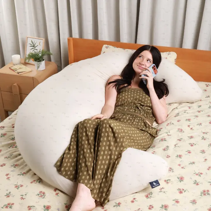 Lounging against the MoonSpoon in bed while on the phone