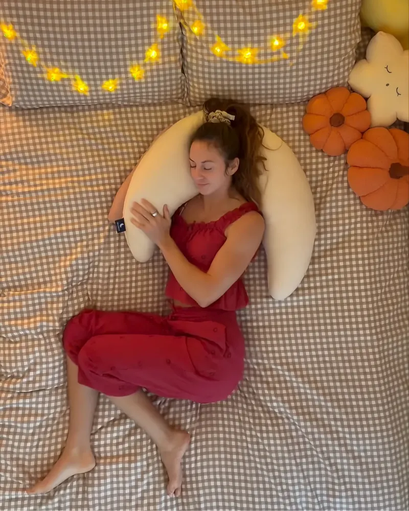 Hugging the Mini Moon™ pillow while dozing off